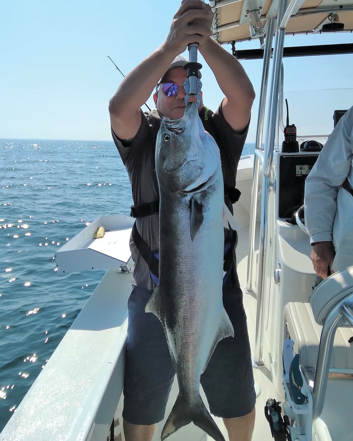 MONSTER BLUEFISH:  John O’Keefe of Jamestown with a 36” bluefish he caught and successfully released this summer.  The fish took first place in the Block Island Inshore Fishing Tournament. (Submitted photo)